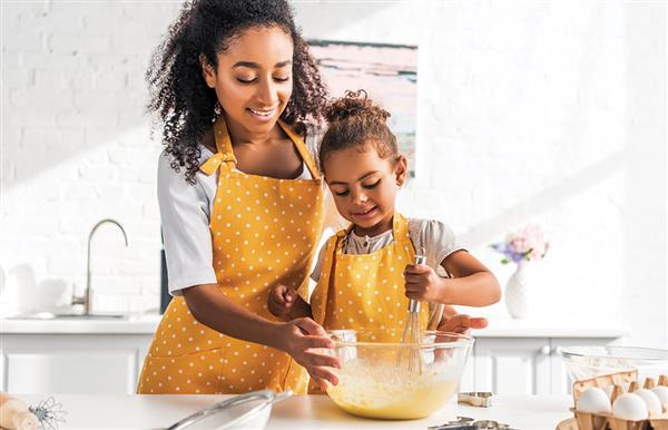 Parent and child cooking together